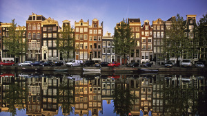 Netherlands Amsterdam Reflection of building in canal called Singel